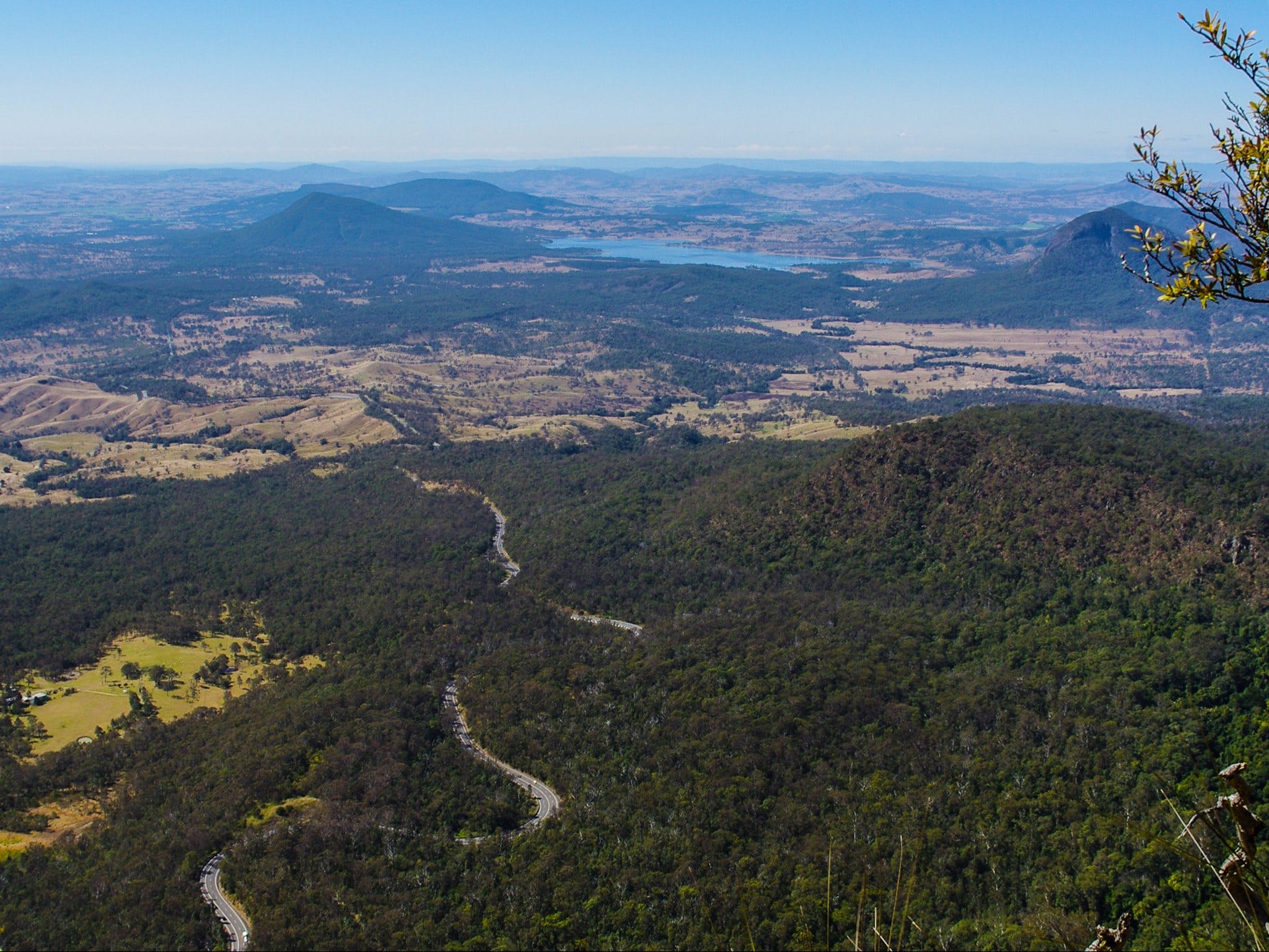 View of mountains, road, lake, farmland and forest.