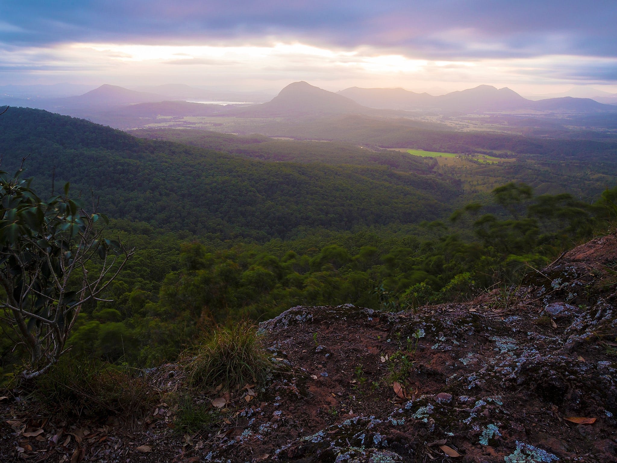 View over flats, mountains and valleys on cloudy day.