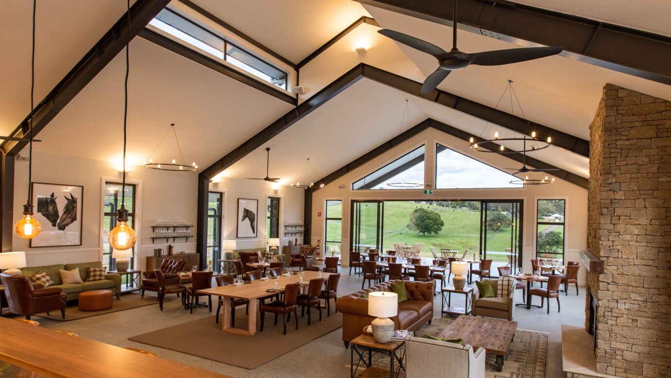 The Paddock restaurant interior featuring floor-to-ceiling windows that maximise hinterland views