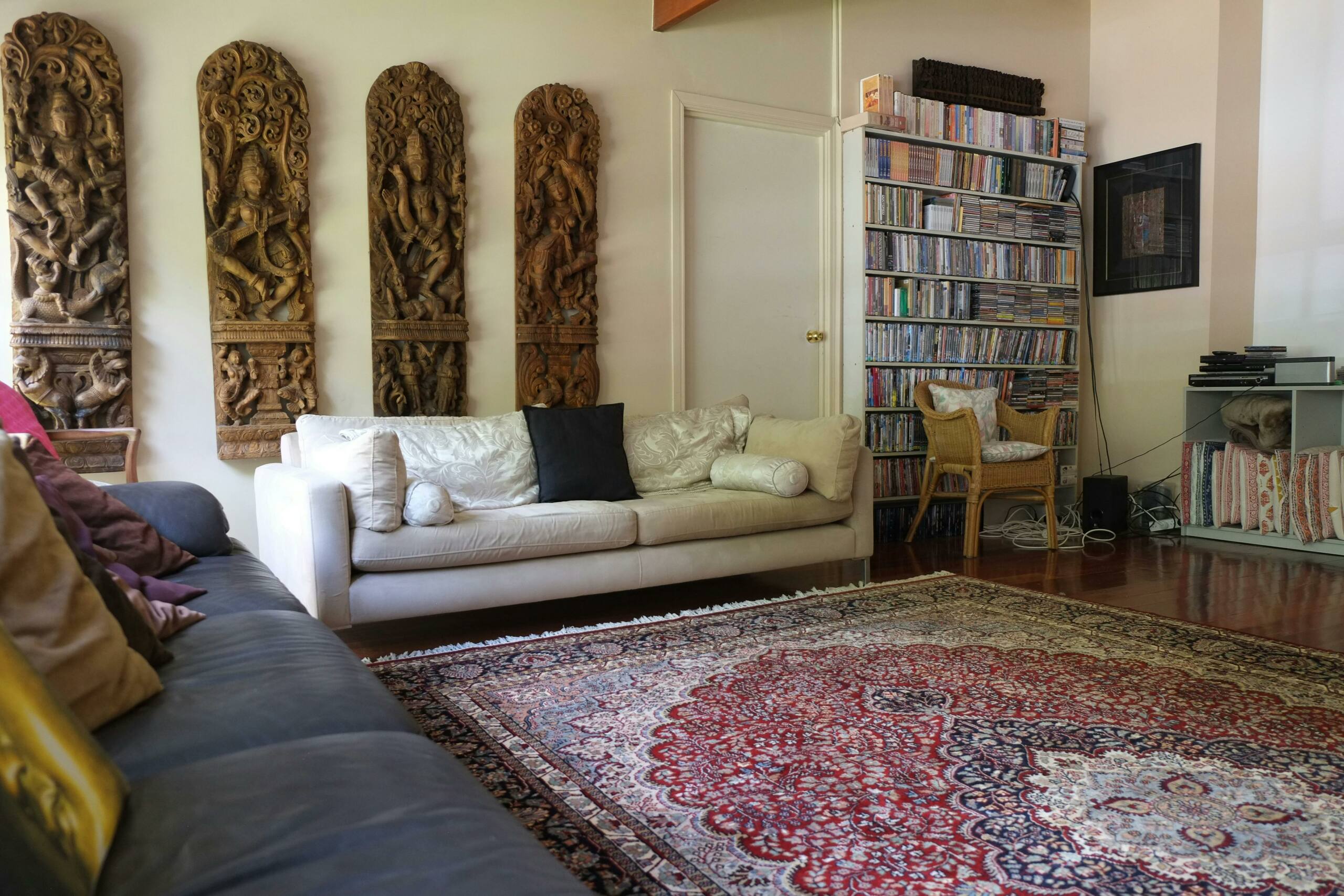 a common area room within Nirvana Wellbeing Retreat with sofas books and dvds