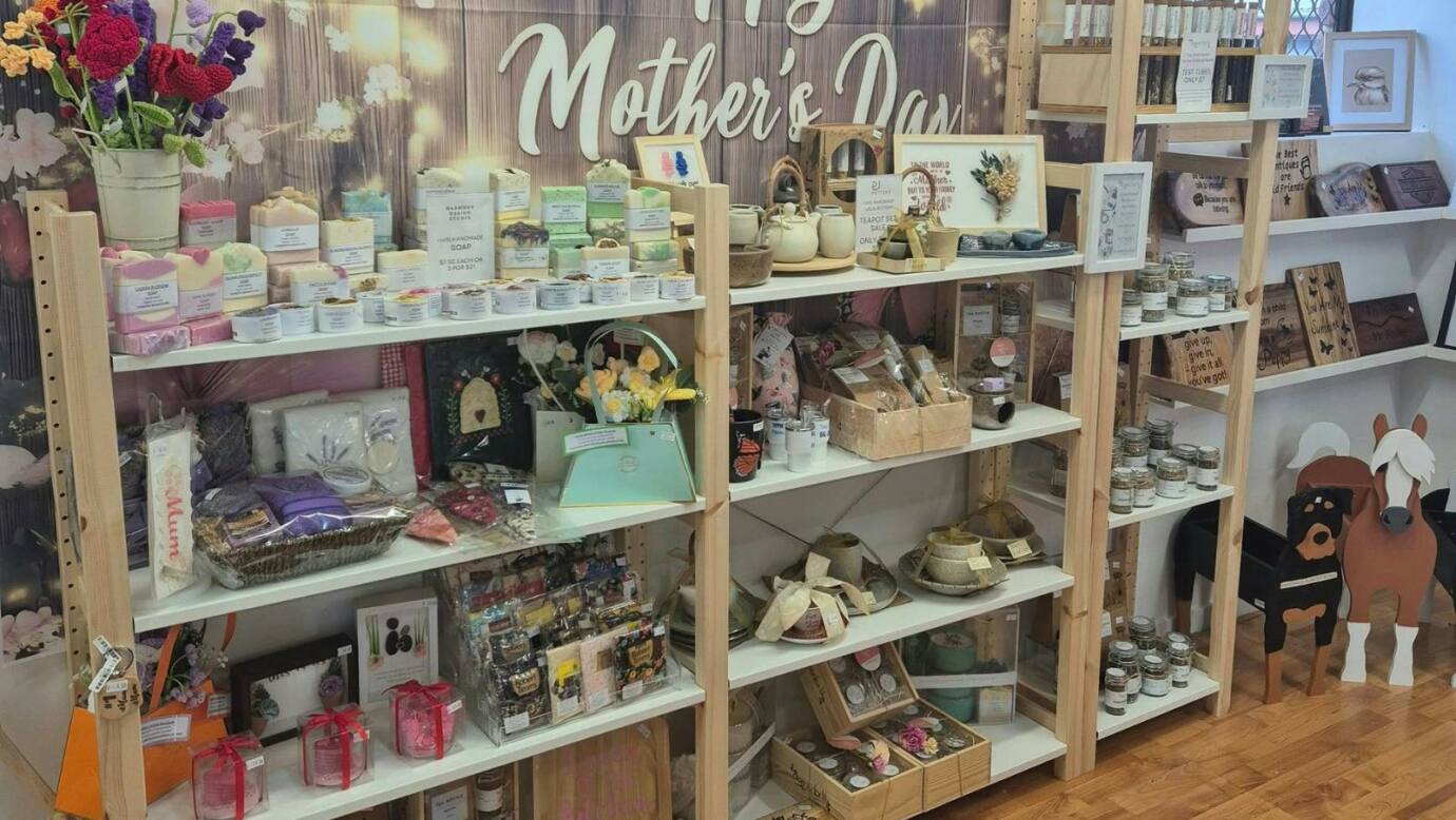 A vibrant Mothers Day retail display filled with handcrafted items