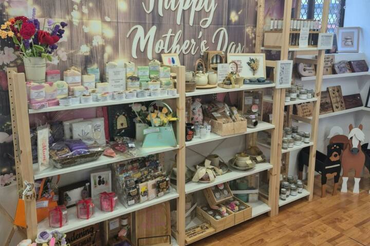 A vibrant Mothers Day retail display filled with handcrafted items