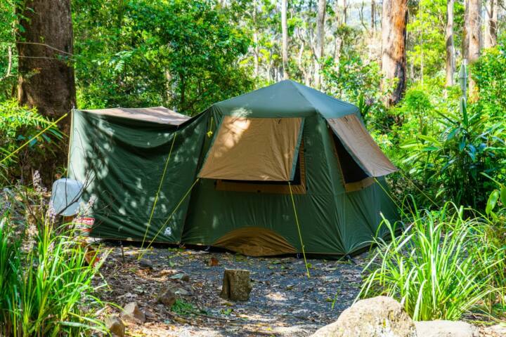 Image shows a large tent set up on a campsite