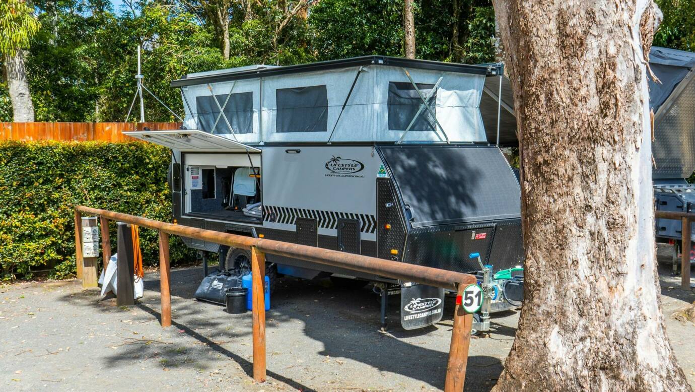 Image shows a caravan set up at the campsite