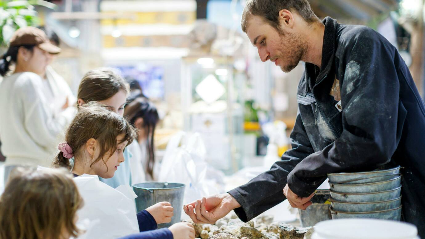 Staff sorting the finds from a family who went fossicking.